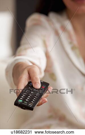 Close-up of female hand with TV remote View Large Photo Image Stock Image - Close-up of female hand with TV remote. Fotosearch
