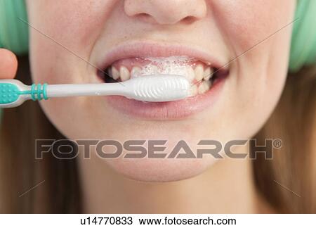 Close up of girl brushing her teeth View Large Photo Image Stock Image - Close up of girl brushing her teeth. Fotosearch