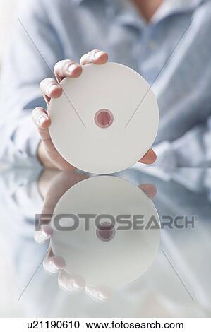 Stock Image - close up of man holding a disc. Fotosearch
