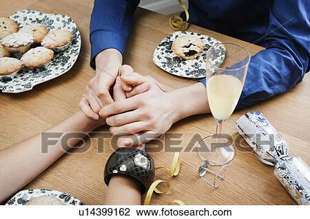 Stock Image - Close up of man holding woman's hands. Fotosearch