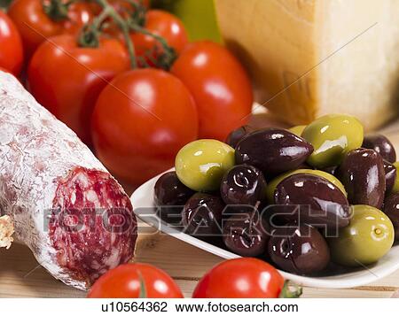 Close up of salami, olives and tomatoes View Large Photo Image Stock Image - Close up of salami, olives and tomatoes. Fotosearch