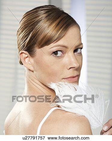 Close up of woman holding feather View Large Photo Image Stock Photo - Close up of woman holding feather. Fotosearch