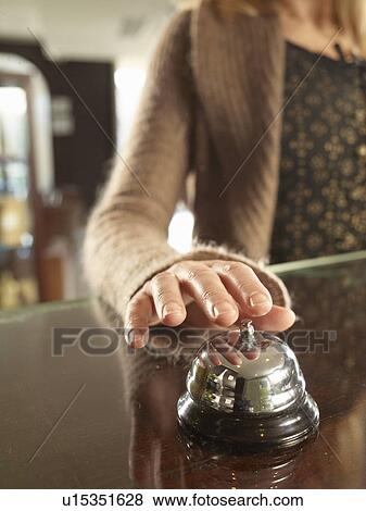 Close up of woman ringin a hotel porters bell View Large Photo Image Stock Photo - Close up of woman ringin a hotel porters bell. Fotosearch