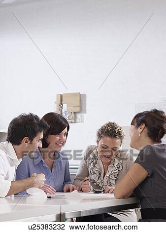 Stock Image - Colleagues having a conference call. Fotosearch