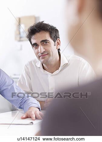 Colleagues having a meeting View Large Photo Image Picture - Colleagues having a meeting. Fotosearch