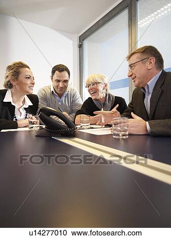 Conference call in a group meeting View Large Photo Image Stock Image - Conference call in a group meeting. Fotosearch