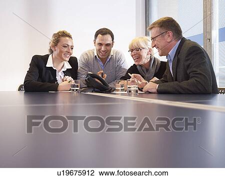 Conference call in a group meeting View Large Photo Image Stock Image - Conference call in a group meeting. Fotosearch