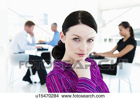 Confident businesswoman with team View Large Photo Image Picture - Confident businesswoman with team. Fotosearch