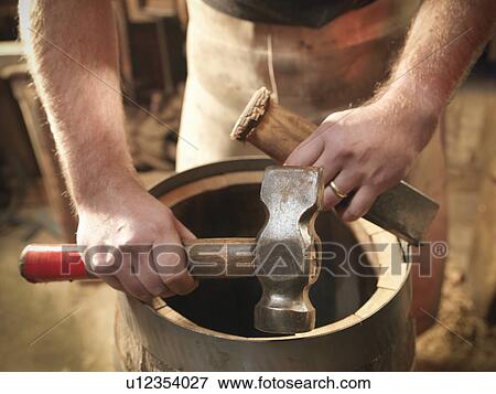 Stock Photo - Cooper with barrel and hammer. Fotosearch