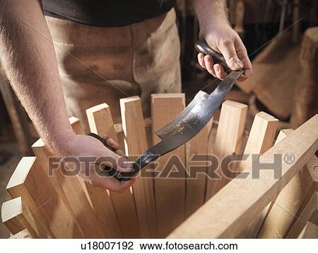 Stock Image - Cooper with barrel-making tools. Fotosearch