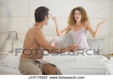 Picture - Couple arguing in bedroom. Fotosearch