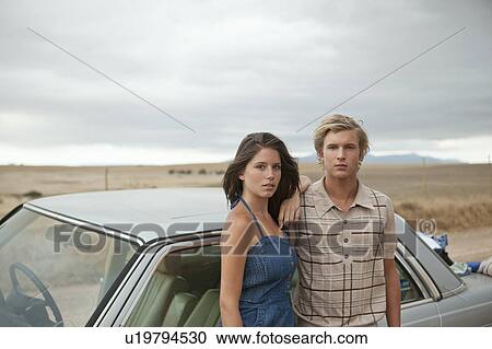 Couple at a car View Large Photo Image Stock Image - Couple at a car. Fotosearch