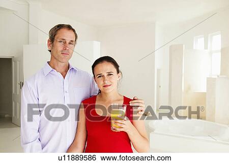 Stock Photograph - Couple at home in bright room. Fotosearch