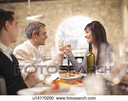 Couple celebrating in restaurant View Large Photo Image Stock Image - Couple celebrating in restaurant. Fotosearch