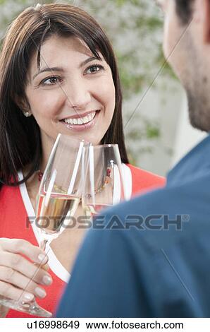 Stock Photo - Couple celebrating together with wine. Fotosearch