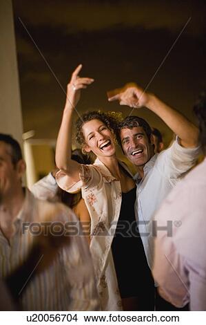 Picture - Couple dancing at party at night. Fotosearch