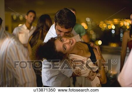 Couple dancing at party at night View Large Photo Image Stock Image - Couple dancing at party at night. Fotosearch
