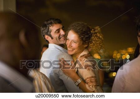 Stock Image - Couple dancing at party at night. Fotosearch