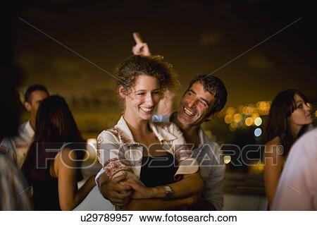 Couple dancing at party at night View Large Photo Image Stock Photo - Couple dancing at party at night. Fotosearch