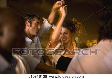 Stock Photography - Couple dancing at party at night. Fotosearch
