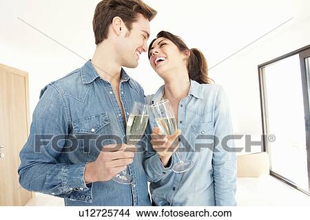 Picture - Couple drinking champagne in new home. Fotosearch