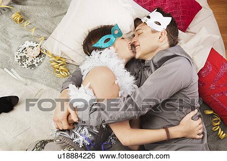 Couple embracing after party View Large Photo Image Stock Photograph - Couple embracing after party. Fotosearch