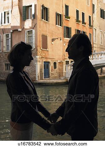 Stock Image - Couple enjoying the beauty of Venice. Fotosearch
