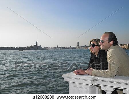 Couple enjoying the beauty of Venice View Large Photo Image Stock Photo - Couple enjoying the beauty of Venice. Fotosearch