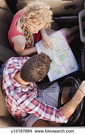 Couple examining map in jeep View Large Photo Image Picture - Couple examining map in jeep. Fotosearch