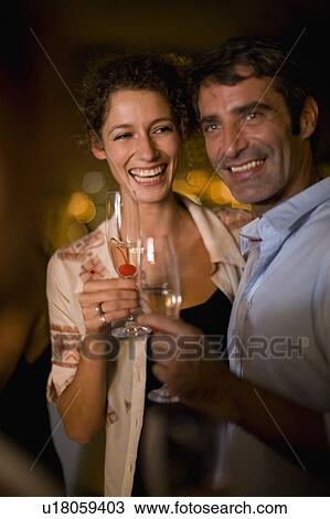Couple having wine on terrace at night View Large Photo Image Stock Image - Couple having wine on terrace at night. Fotosearch