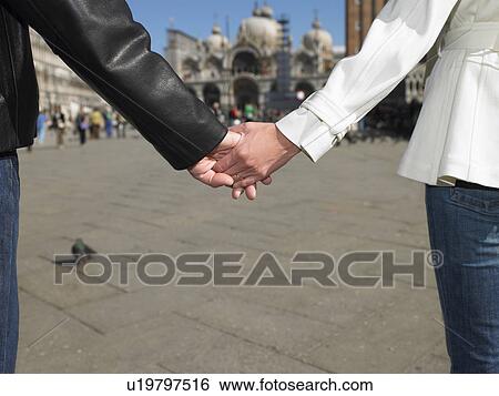 Couple holding hands in Venice, Italy View Large Photo Image Stock Photograph - Couple holding hands in Venice, Italy. Fotosearch