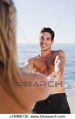 Couple holding hands on beach View Large Photo Image Stock Image - Couple holding hands on beach. Fotosearch
