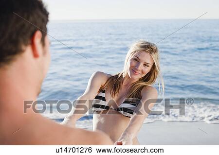 Couple holding hands on beach View Large Photo Image Stock Photograph - Couple holding hands on beach. Fotosearch