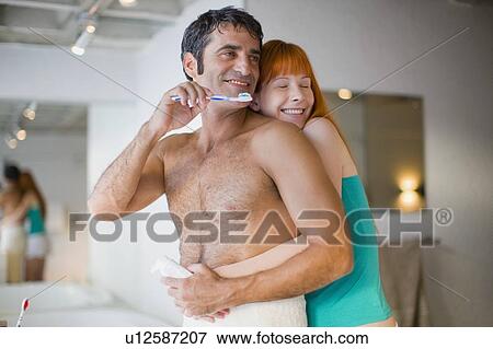 Stock Photo - Couple hugging in bathroom. Fotosearch