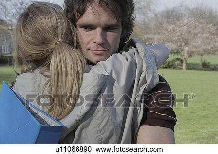 Couple hugging in park View Large Photo Image Stock Image - Couple hugging in park. Fotosearch