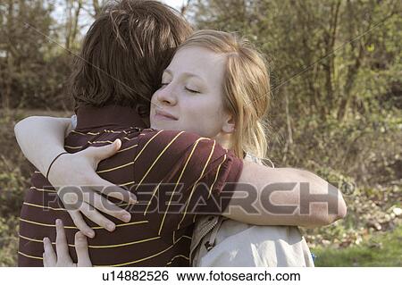 Stock Photograph - Couple hugging in park. Fotosearch