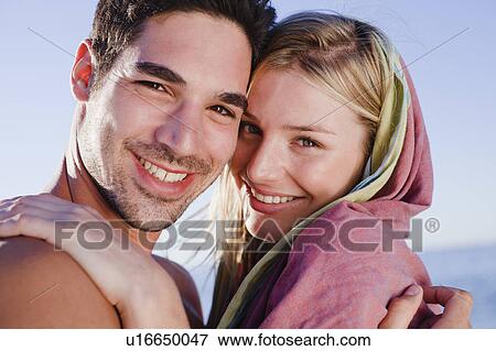 Couple hugging on beach View Large Photo Image Stock Photo - Couple hugging on beach. Fotosearch
