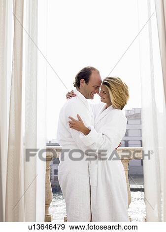 Couple in bath robe on the balcony View Large Photo Image Stock Photo - Couple in bath robe on the balcony. Fotosearch