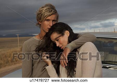 Stock Photo - Couple in front of car. Fotosearch