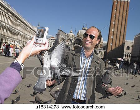 Stock Image - Couple in Venice, taking pictures. Fotosearch