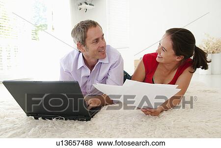 Couple joke when sorting out bills View Large Photo Image Stock Photo - Couple joke when sorting out bills. Fotosearch