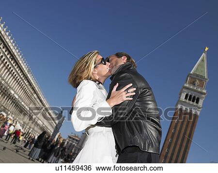 Stock Photograph - Couple kissing in venice, Italy. Fotosearch