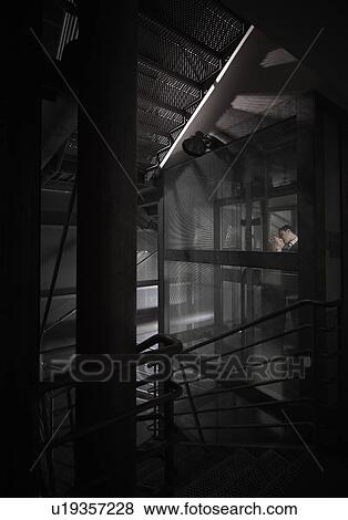 Couple kissing late in a lift View Large Photo Image Stock Photo - Couple kissing late in a lift. Fotosearch