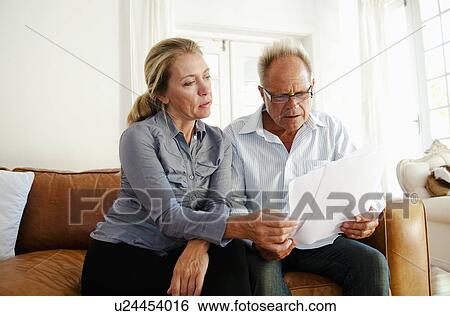Couple look through bills View Large Photo Image Stock Photograph - Couple look through bills. Fotosearch