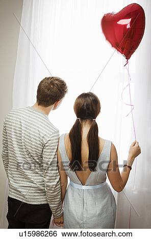 Stock Photograph - Couple looking out of window. Fotosearch