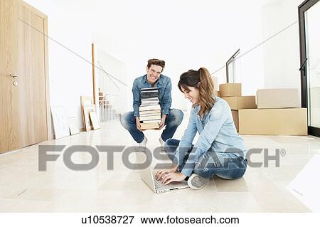 Couple moving into new home View Large Photo Image Stock Photo - Couple moving into new home. Fotosearch