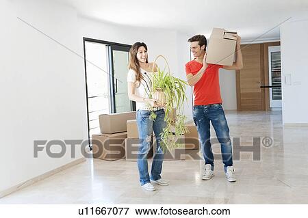 Stock Photo - Couple moving into new home. Fotosearch