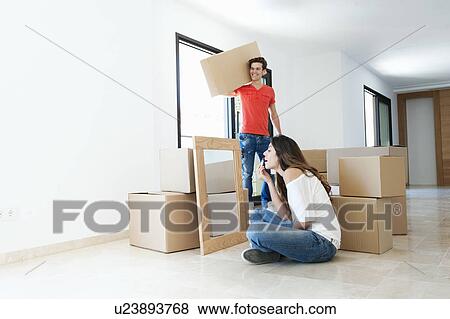 Stock Photo - Couple moving into new home. Fotosearch