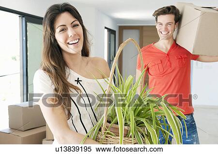 Stock Photography - Couple moving into new home. Fotosearch