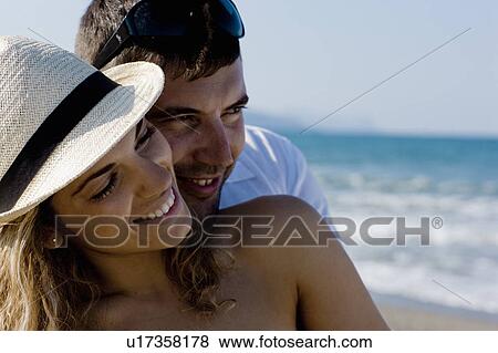 couple on the beach cuddling View Large Photo Image Stock Photo - couple on the beach cuddling. Fotosearch